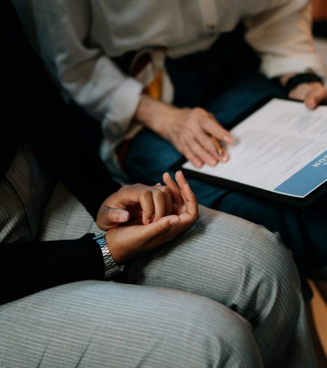Two professionals reviewing a resume in an office setting, focused on teamwork.